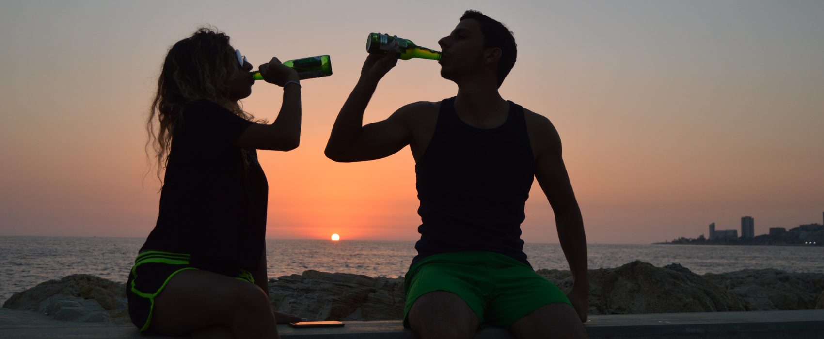 woman and man holding drinking bottles